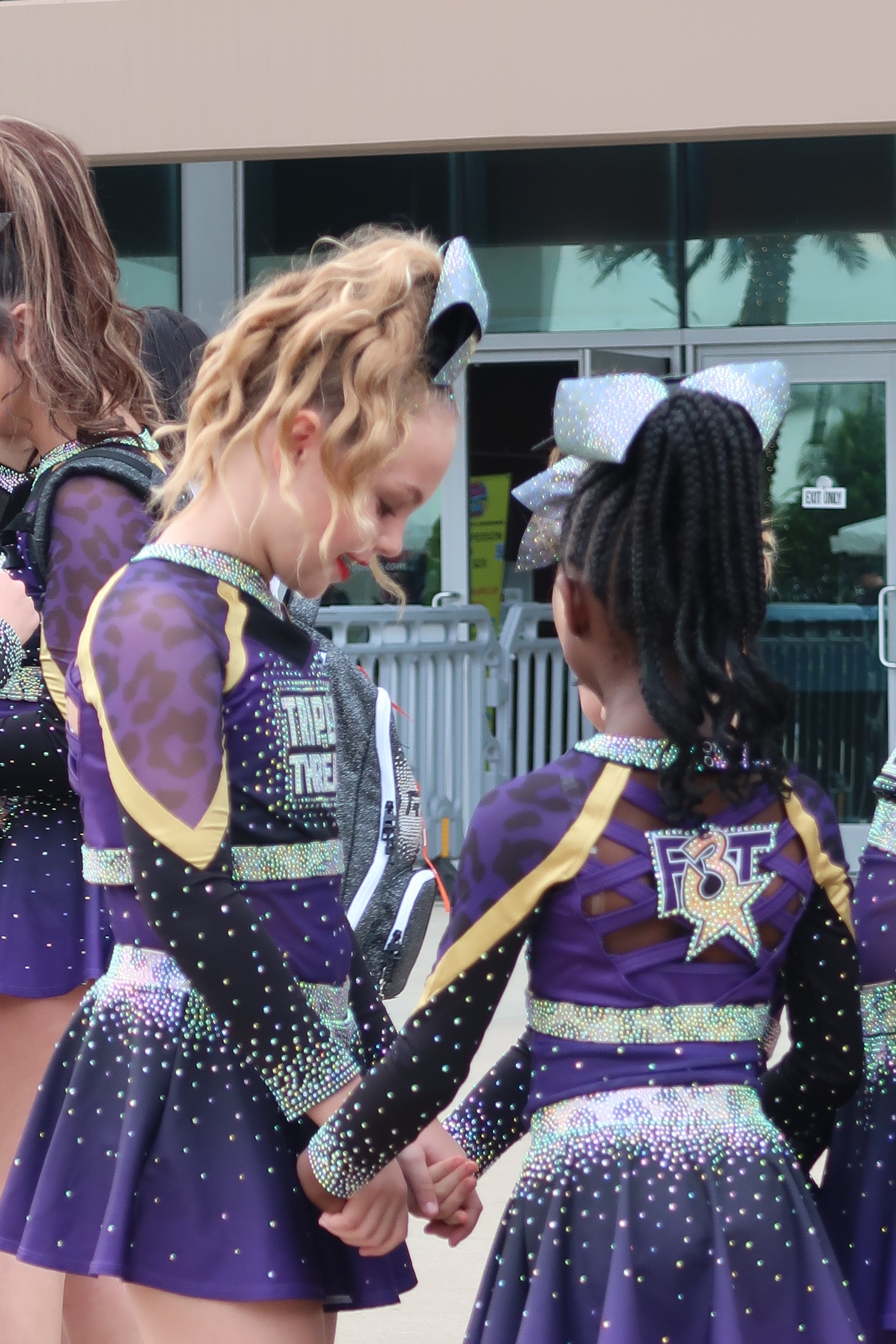 Two F3T teammates in uniform holding hands